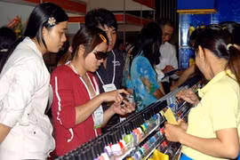 Customers buy cosmetics at a trade fair in HCM City. Viet Nam's cosmetic market is seen as having huge potential, with turnover of roughly US$704.2 million every year. (Photo: VNA/VNS)