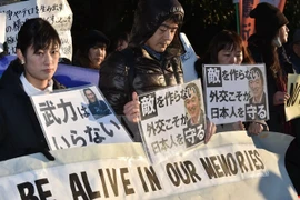 Japanese people in a silent march in Tokyo to protest the barbaric acts. Photo: AFP/VNA.