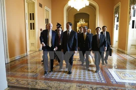 Minister of Public Security Tran Dai Quang (front, right) and Senator John McCain (front, left) (Photo: VNA)
