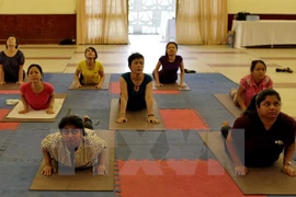 Locals take part in a yoga class. Photo: VNA