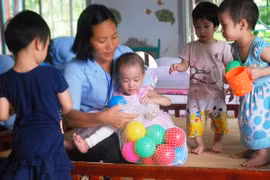 Caring for abandoned children in an social sponsoring centre (Photo: VNA)