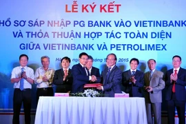 Leaders of the two banks sign the merger document. (Photo: Vietinbank)