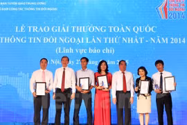 Politburo members Le Hong Anh (third, right) and Dinh The Huynh (second, left) and first prize winners (Photo: VNA)