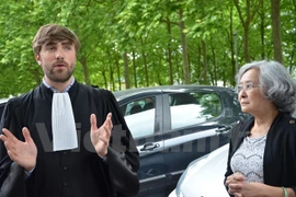 Bertrand Repolt (L) and Tran To Nga speak to the press after the hearing on June 18 (Photo: VNA)