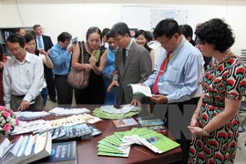 Visitors look at publications at the centre (Photo: VNA)