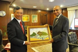 Vietnamese Ambassador Nguyen Xuan Luu (L) presents a picture of iconic one-pillar pagoda to Pakistani Deputy Minister Chaudhry (Photo:VNA)