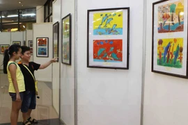 Visitors to an exhibition on children’s paintings (Photo: VNA)