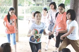 Children enjoy a traditional game which was once popular years ago at the two-day festival at the Vietnam Museum of Ethnology (Photo: VNA)