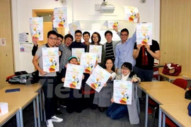UCL students pose for a photo to promote the day (Photo: VNA)