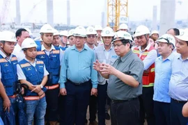 Prime Minister Pham Minh Chinh and representatives of project units at the construction site. (Photo: VNA)