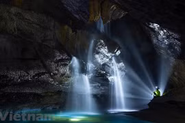 Exploring waterfall in million-year-old cave
