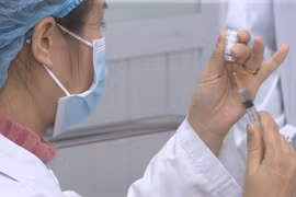 First persons receive injections of COVID-19 vaccine in Vietnam
