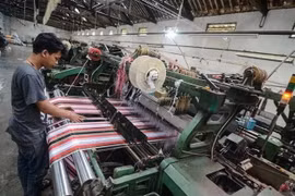 A worker completes production of sarong cloth in a textile factory in Majalaya industrial estate in Bandung regency, West Java. (Photo: Antara) 