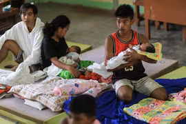 Evacuees rest inside an evacuation center set up at a school in a village in Canlaon, Negros Occidental province, central Philippines on June 4, 2024. (Photo: AFP) 