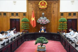 Prime Minister Pham Minh Chinh chairs a meeting on the monetary policy with leaders of the State Bank of Vietnam (SBV), the Ministry of Finance, the Ministry of Planning and Investment, and other ministries and agencies. (Photo: VNA)