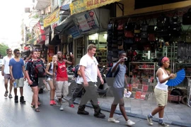 Foreign tourists visit Hanoi's Old Quarter (Photo: VNA)