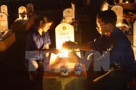 Candles are lit at graves of revolutionaries and soldiers at the Road 9 National Martyrs Cemetery in Quang Tri.