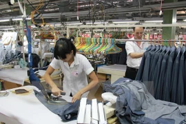 A worker irons garment for export (Photo: VNA)