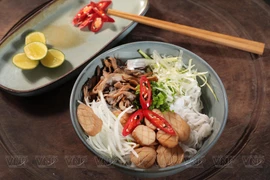 Enjoying vegetarian pho in Hanoi