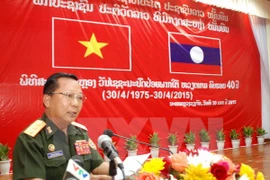 Lao Deputy Defence Minister Chansamon Channhalat delivers addresses the event (Photo: VNA)