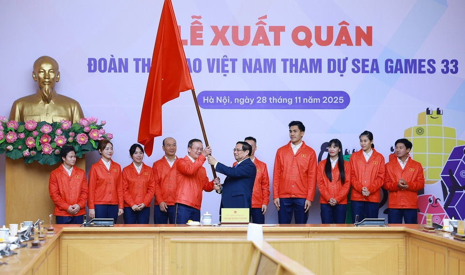 Prime Minister Pham Minh Chinh presents the flag to the Vietnamese sports delegation heading to the 33rd SEA Games. (Photo: VNA)