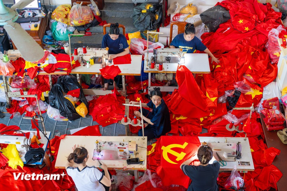 In workshops and households, machines run non-stop, with flags meticulously crafted by hand. (Photo: Vietnam+)