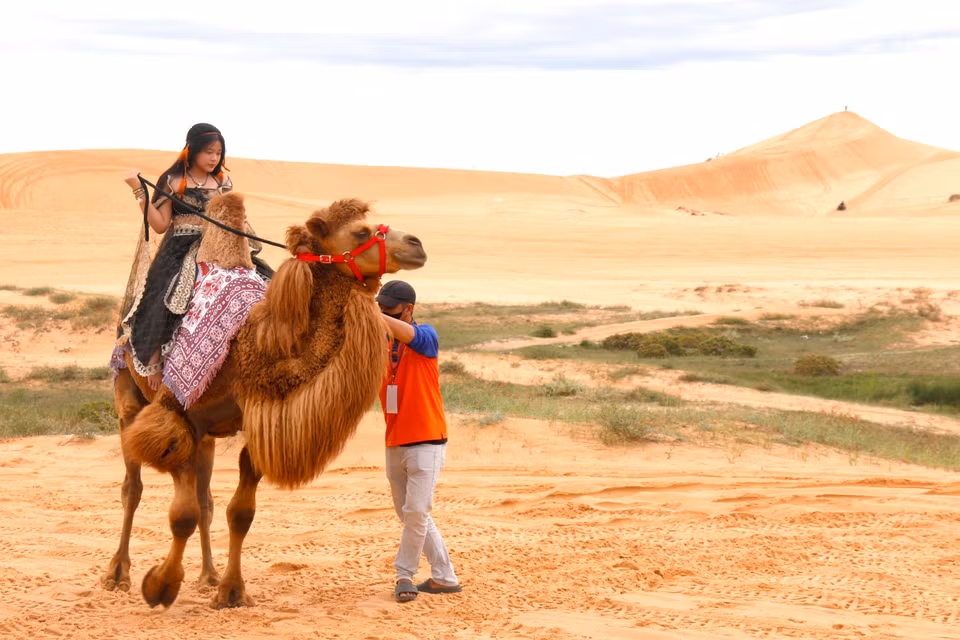 Riding camels at Bau Trang Scenic Site, part of the Mui Ne National Tourist Area plan, is a popular activity among visitors. (Photo: VNA)