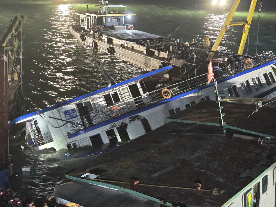 At around 1:30am on July 20, the tourist boat QN-7105, which capsized in Ha Long Bay on July 19, is lifted to the surface. (Photo: VNA)