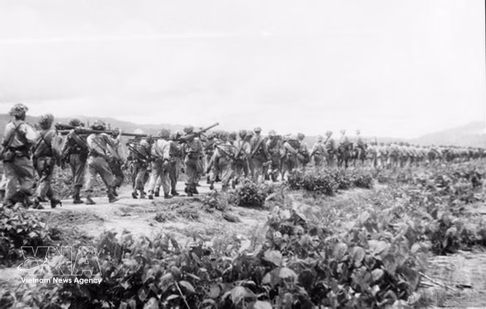 Troops march through forests and crossed streams on their way to the battlefield. (Photo: VNA)