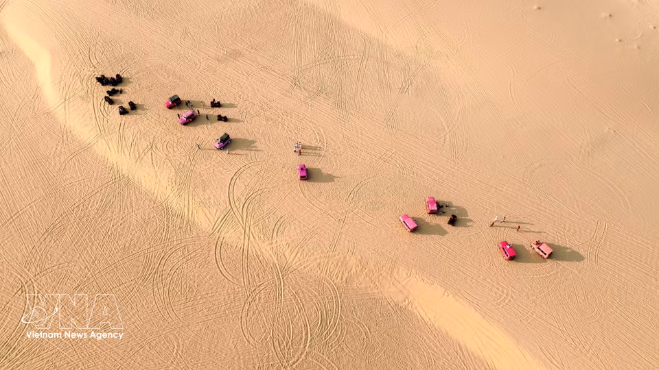 Tourist vehicles add vibrant touches of colour to the Mui Dinh sand dunes. (Photo: VNA)