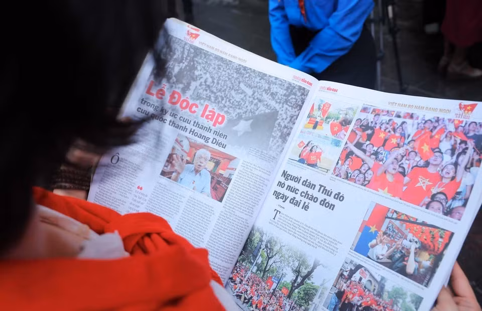A reader with the Tin Tuc special edition. (Photo: VNA)