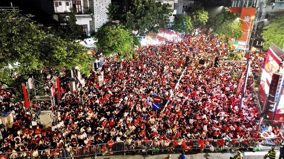 A wave of flags and flowers turns Hanoi’s streets red as crowds welcome the National Day parade. (Photo: VNA)