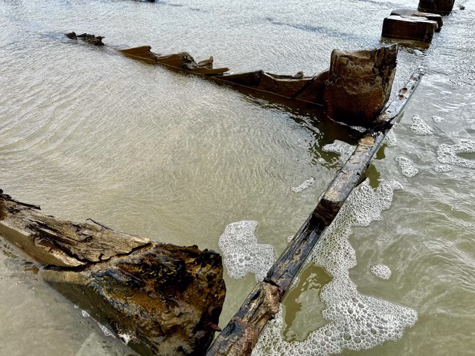 The vessel’s wooden frame rises above the sand. (Photo: VNA)