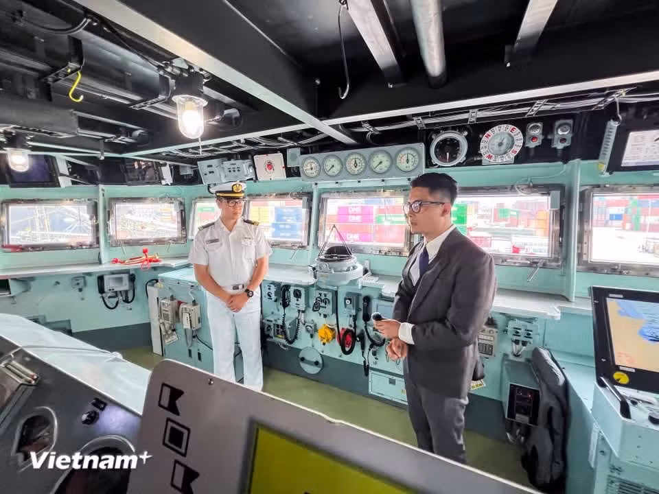 Japanese officers explain the ship’s navigation and control equipment to visitors inside the bridge. (Photo: VietnamPlus)