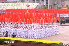 The formation featuring the Party flag and the national flag at the parade marking the 80th anniversary of the August Revolution and National Day on September 2, 2025 (Photo: VNA)