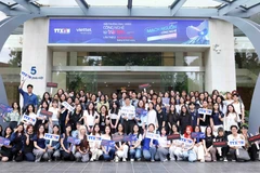 Students from the Academy of Journalism and Communication attend the symposium that highlights the heartbeat of tehnology as a source of happiness. (Photo: VNA)