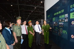 Deputy PM Le Thanh Long (second from right) visits an exhibition highlighting anti-drug efforts. (Photo: VNA)