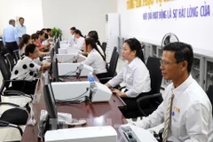 Seamless public services for citizens and businesses must be ensured during the transition to a streamlined two-tier local administration model. (Photo: VNA)