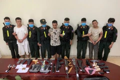 The group of Chinese nationals are arrested for illegal border crossings and the illegal transport of military-grade weapons and suspected narcotics. (Photo: VNA)