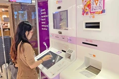 A customer at TPBank's LiveBank - the first auto banking system in Vietnam (Photo: Hanoimoi.vn)