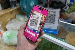 A local resident makes a bank transfer using the Momo app. (Photo: VNA)