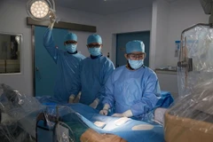 Dr Ho Minh Tuan performs the cardiac catheterisation procedure on the patient. (Photo courtesy of the hospital)