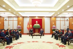 Party General Secretary To Lam (right) receives Chinese Minister of National Defence Senior Lieutenant General Dong Jun and a delegation from the Chinese People's Liberation Army in Hanoi on December 19. (Photo: VNA)