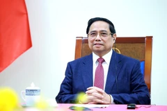 Vietnamese Prime Minister Pham Minh Chinh at the phone talks with his Singaporean counterpart Lawrence Wong on December 18. (Photo: VNA)