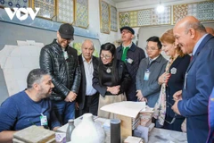 Le Thi Bich Tran, Prime Minister Pham Minh Chinh’s spouse, is briefed on the centre's activities and the daily lives of the children there. (Photo: VNA)