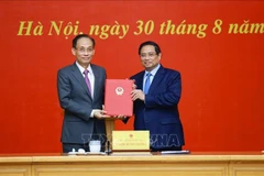 Prime Minister Pham Minh Chinh hands over the decision to assign Le Hoai Trung, Secretary of the Party Central Committee and Chief of the Party Central Committee Office, as Acting Minister of Foreign Affairs in Hanoi on August 30. (Photo: VNA)