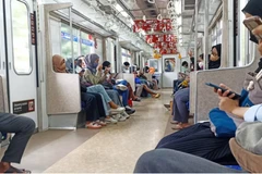 People are seen using an electric train (KRL) in Jakarta, Indonesia. (Photo: channelnewsasia.com)