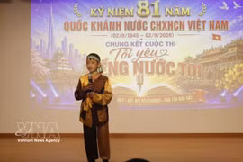 Eight-year-old contestant Duc An singing a Vietnamese song at the contest. (Photo: VNA)