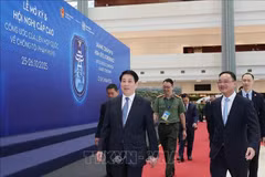 State President Luong Cuong (L) inspects preparations for the signing ceremony of the United Nations Convention against Cybercrime at the National Convention Centre in Hanoi. (Photo: VNA)