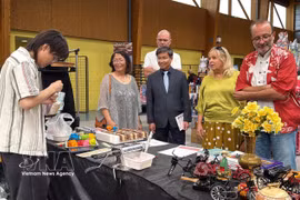 Visitors explore a space showcasing Vietnam’s traditional "to he" figurine-making art at the fourth Maintenon/Pierres Japan Festival. (Photo: VNA) 